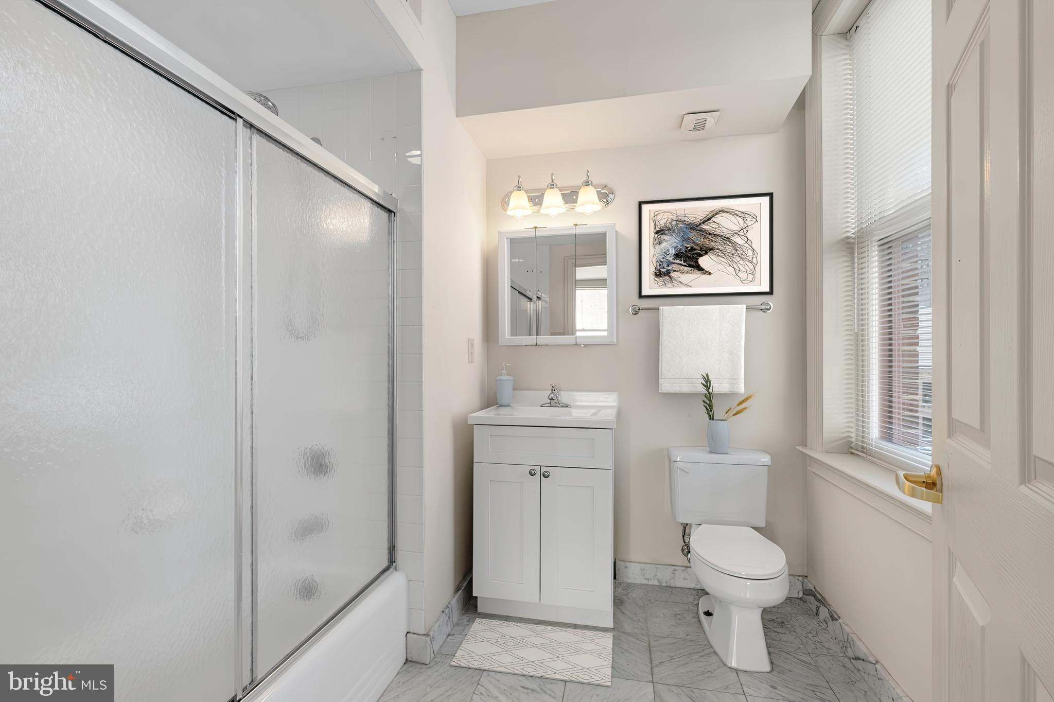 204 South 17th Street, Unit 5H Philadelphia, PA 19103 - Photo 4 of 15 a bathroom with a toilet sink and shower