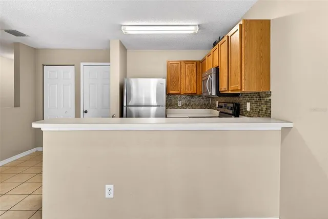 a view of kitchen with granite countertop cabinets