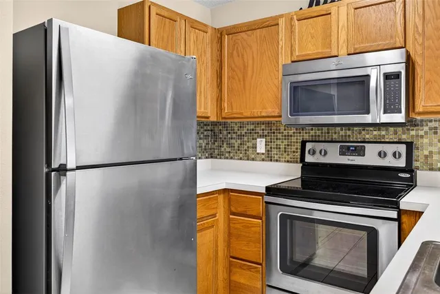 a kitchen with a stove microwave and refrigerator