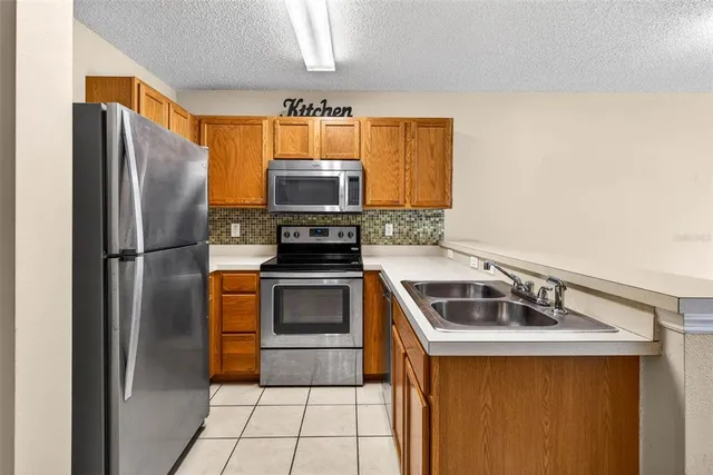 a kitchen with stainless steel appliances a refrigerator and a sink