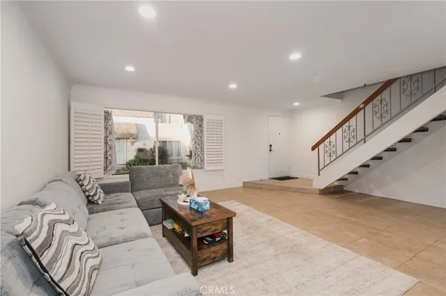 a living room with furniture and stairs