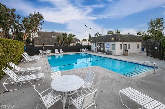 a view of a patio with table and chairs and potted plants