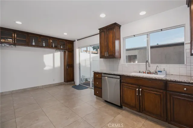 a large kitchen with stainless steel appliances granite countertop a sink and cabinets