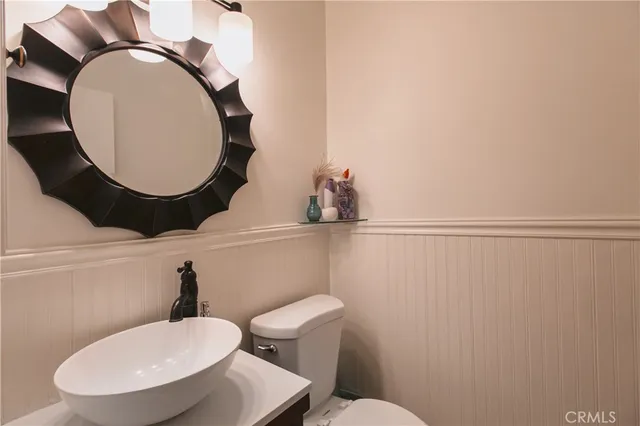 a living room with furniture and hard wood flooring