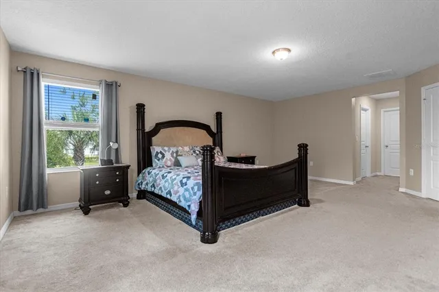 a bed room with a bed and a large window