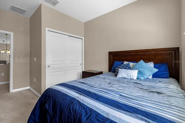 a bedroom with a large bed and a window