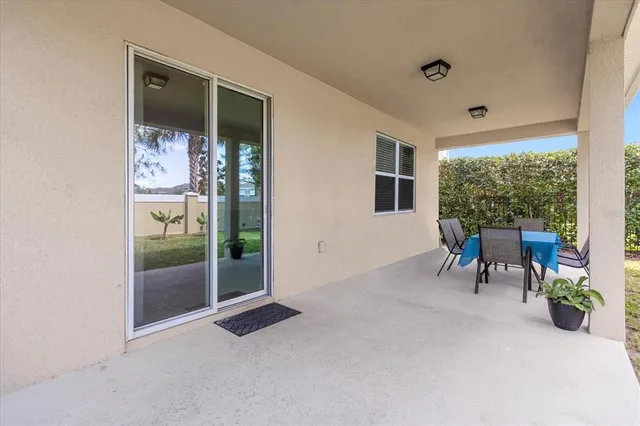 a view of a porch with chairs and backyard