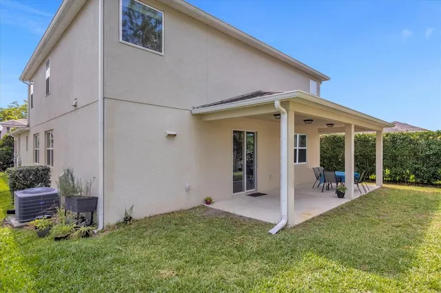 a view of a house with backyard porch and sitting area