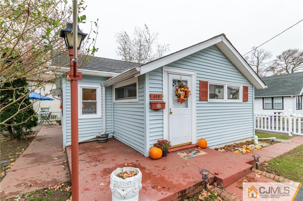 a view of a house with a wooden fence