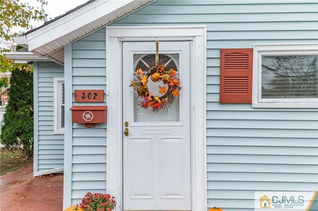 302 Norwood Avenue Old Bridge, NJ 08879 - Photo 2 of 19 a front view of a house with glass windows and door