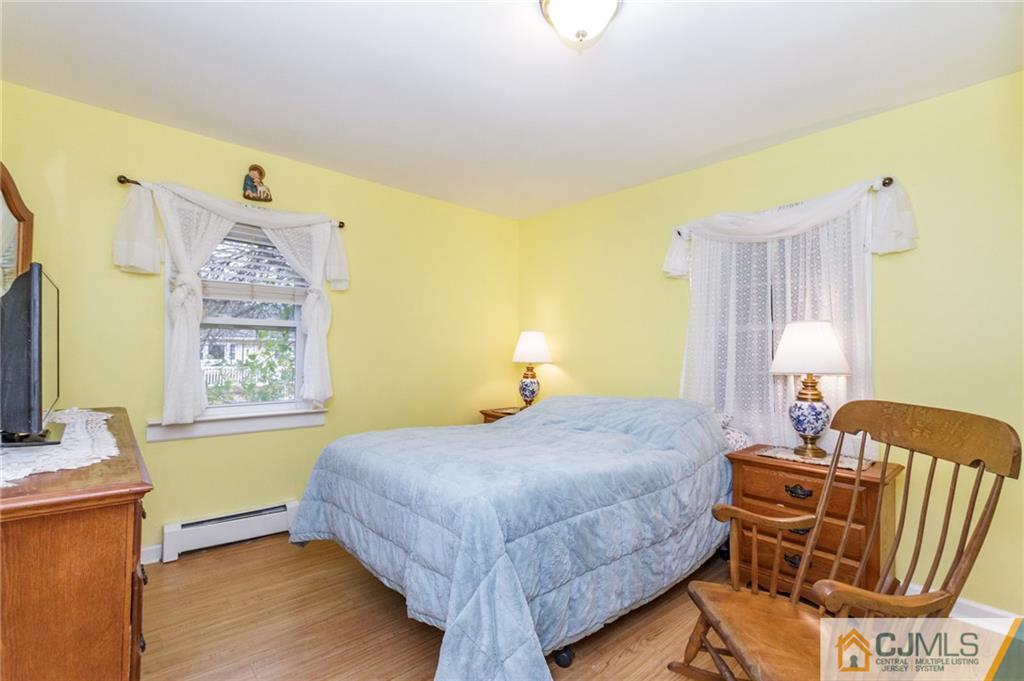 302 Norwood Avenue Old Bridge, NJ 08879 - Photo 11 of 19 a bedroom with a bed and wooden floor