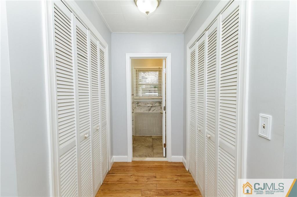302 Norwood Avenue Old Bridge, NJ 08879 - Photo 13 of 19 a view of a hallway with windows