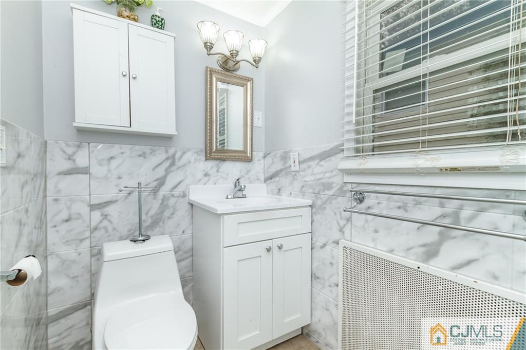 302 Norwood Avenue Old Bridge, NJ 08879 - Photo 14 of 19 a bathroom with a toilet sink and mirror