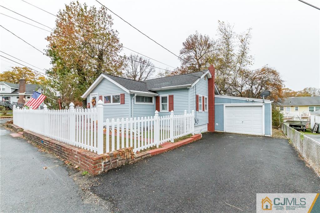 302 Norwood Avenue Old Bridge, NJ 08879 - Photo 19 of 19 a view of a house with a yard and wooden fence