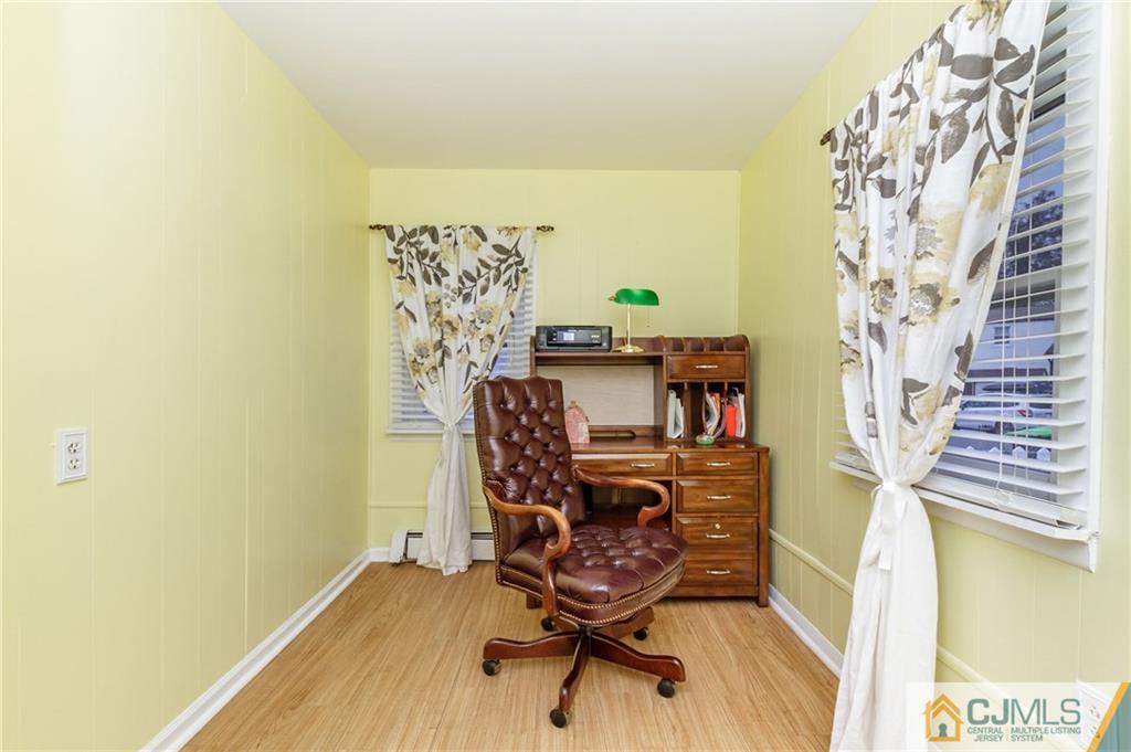 302 Norwood Avenue Old Bridge, NJ 08879 - Photo 4 of 19 a view of a workspace with furniture and a window