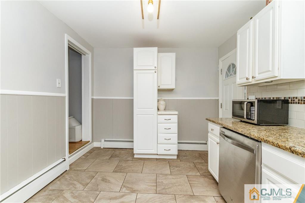 302 Norwood Avenue Old Bridge, NJ 08879 - Photo 10 of 19 a kitchen with a stove and a refrigerator