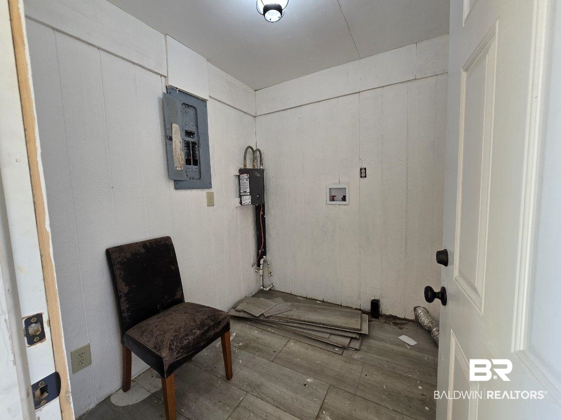 6464 Ridge Road Brewton, AL 36426 - Photo 14 of 14 Laundry area featuring electric panel, hookup for a washing machine, and hardwood / wood-style floors