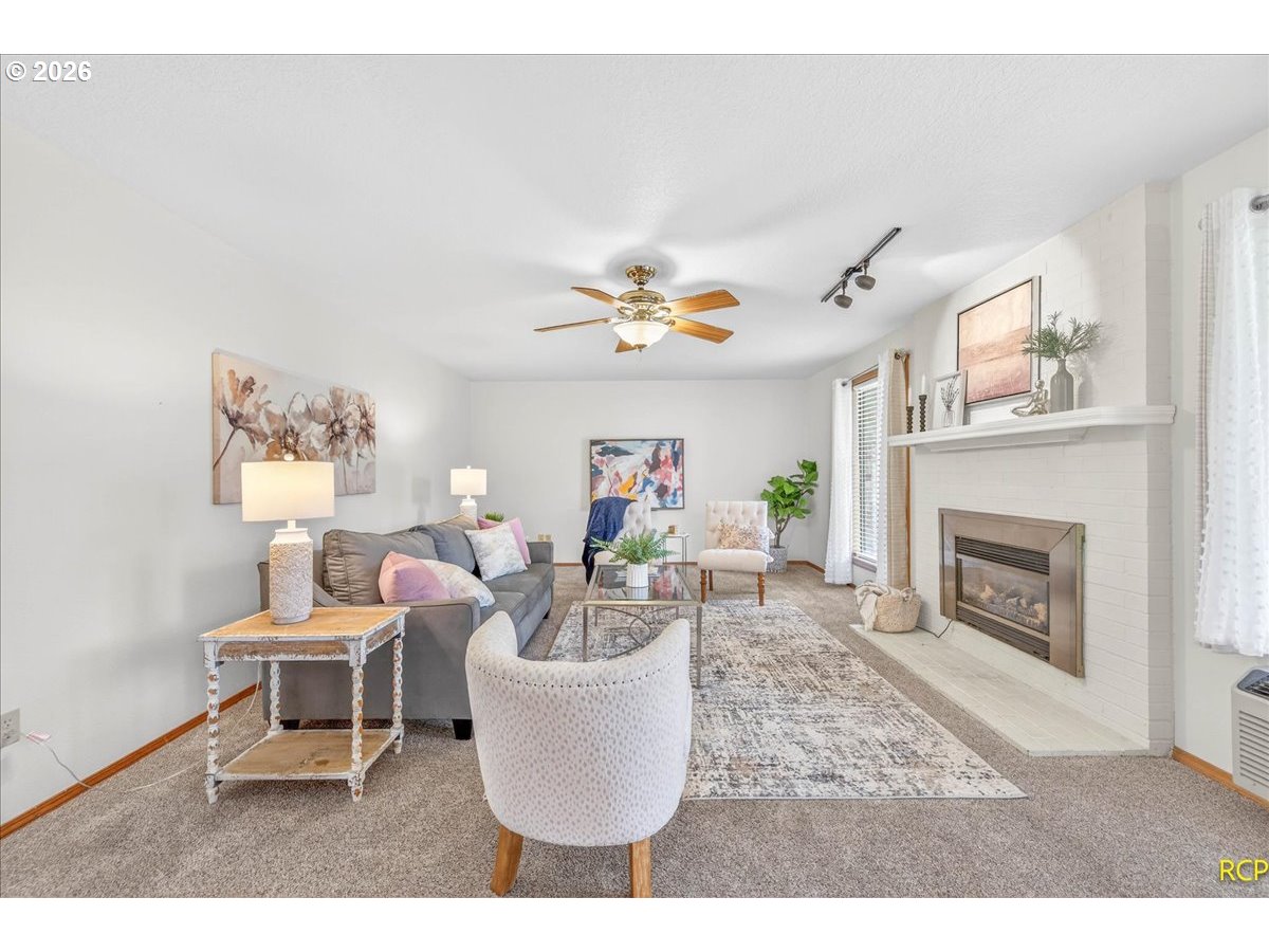 16444 Southwest 130th Terrace, Unit 121 Portland, OR 97224 - Photo 13 of 40 a living room with furniture and a fireplace