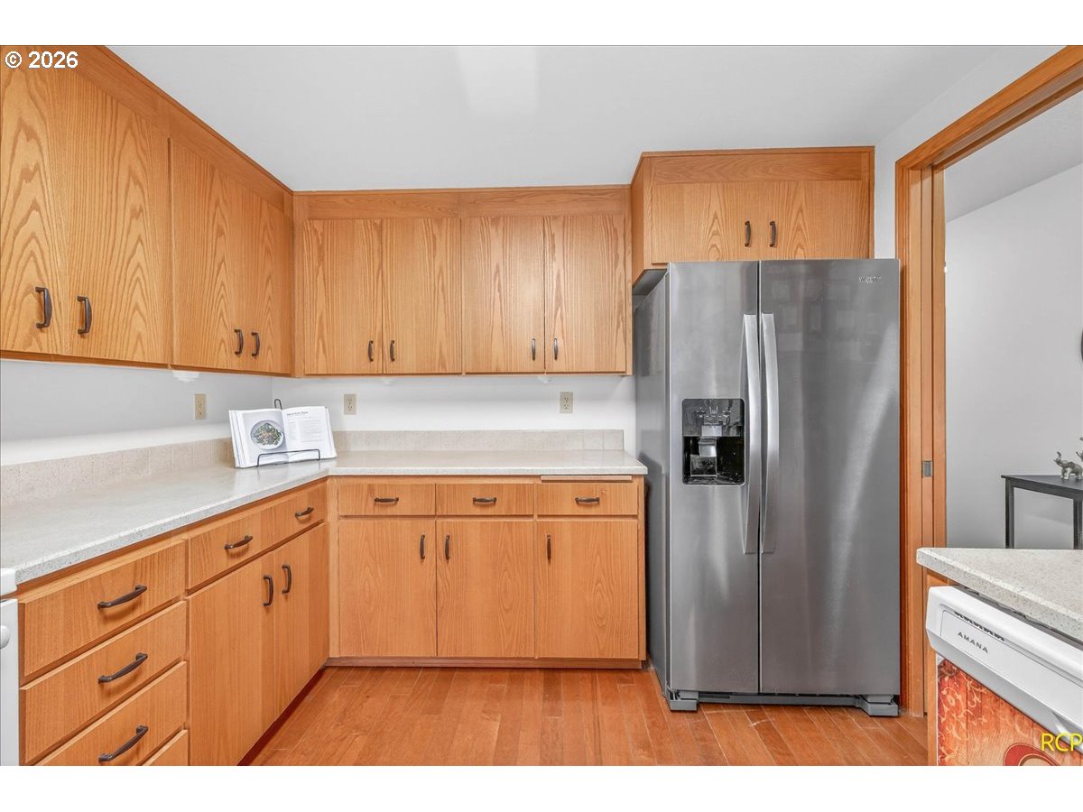 16444 Southwest 130th Terrace, Unit 121 Portland, OR 97224 - Photo 20 of 40 a kitchen with stainless steel appliances granite countertop a refrigerator and a sink