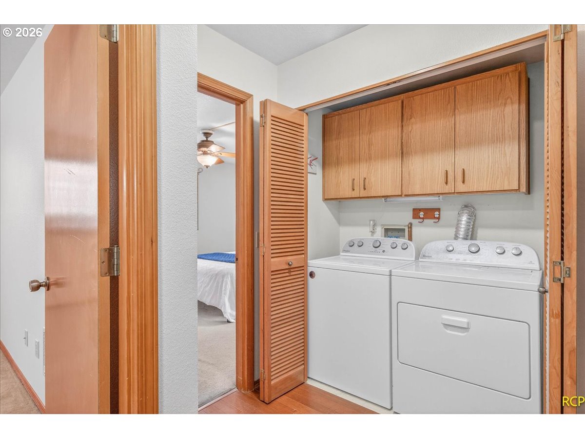 16444 Southwest 130th Terrace, Unit 121 Portland, OR 97224 - Photo 22 of 40 a view of bathroom with a sink cabinet and a window