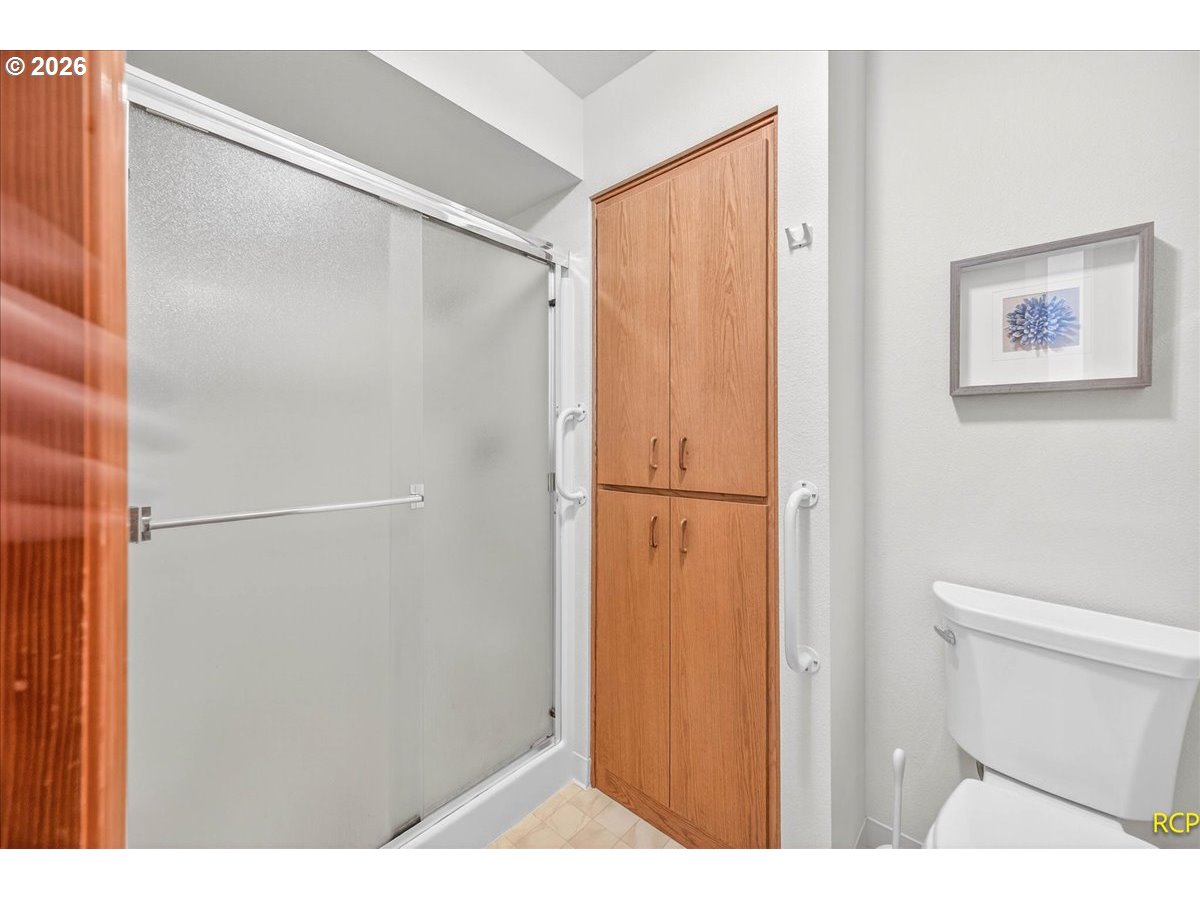 16444 Southwest 130th Terrace, Unit 121 Portland, OR 97224 - Photo 31 of 40 a bathroom with a shower and a toilet