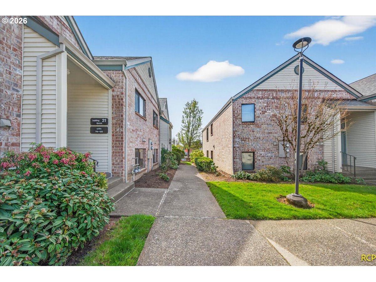 16444 Southwest 130th Terrace, Unit 121 Portland, OR 97224 - Photo 32 of 40 a view of a house with a yard