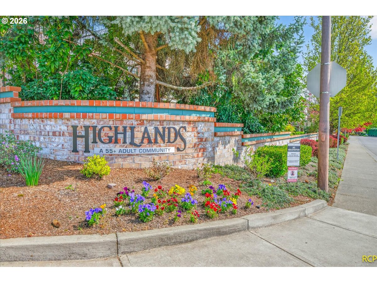 16444 Southwest 130th Terrace, Unit 121 Portland, OR 97224 - Photo 34 of 40 a view of outdoor space with sign board and garden