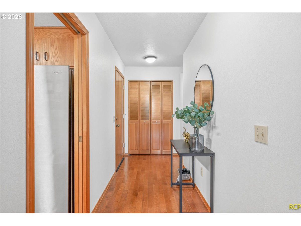 16444 Southwest 130th Terrace, Unit 121 Portland, OR 97224 - Photo 7 of 40 a view of a room with wooden floor table and windows