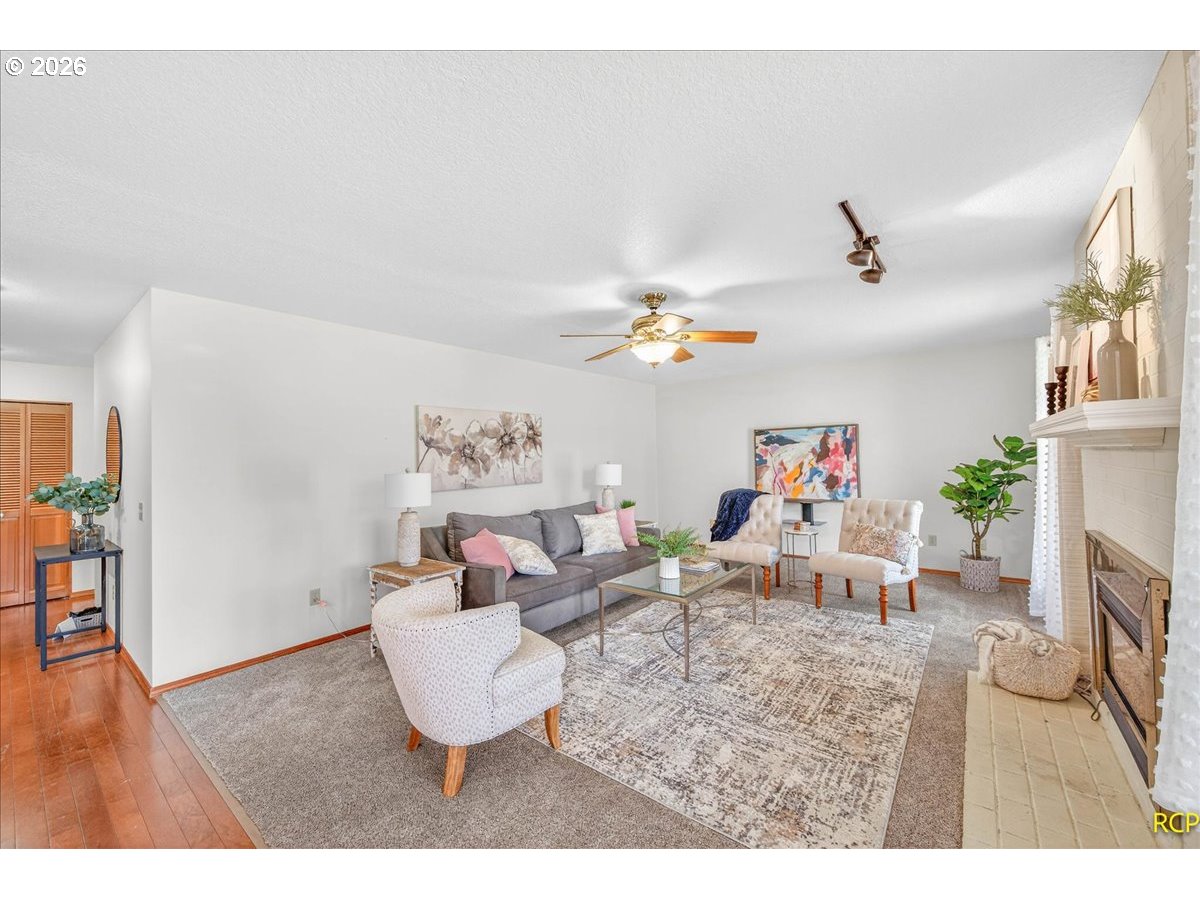 16444 Southwest 130th Terrace, Unit 121 Portland, OR 97224 - Photo 9 of 40 a living room with furniture and a dining area