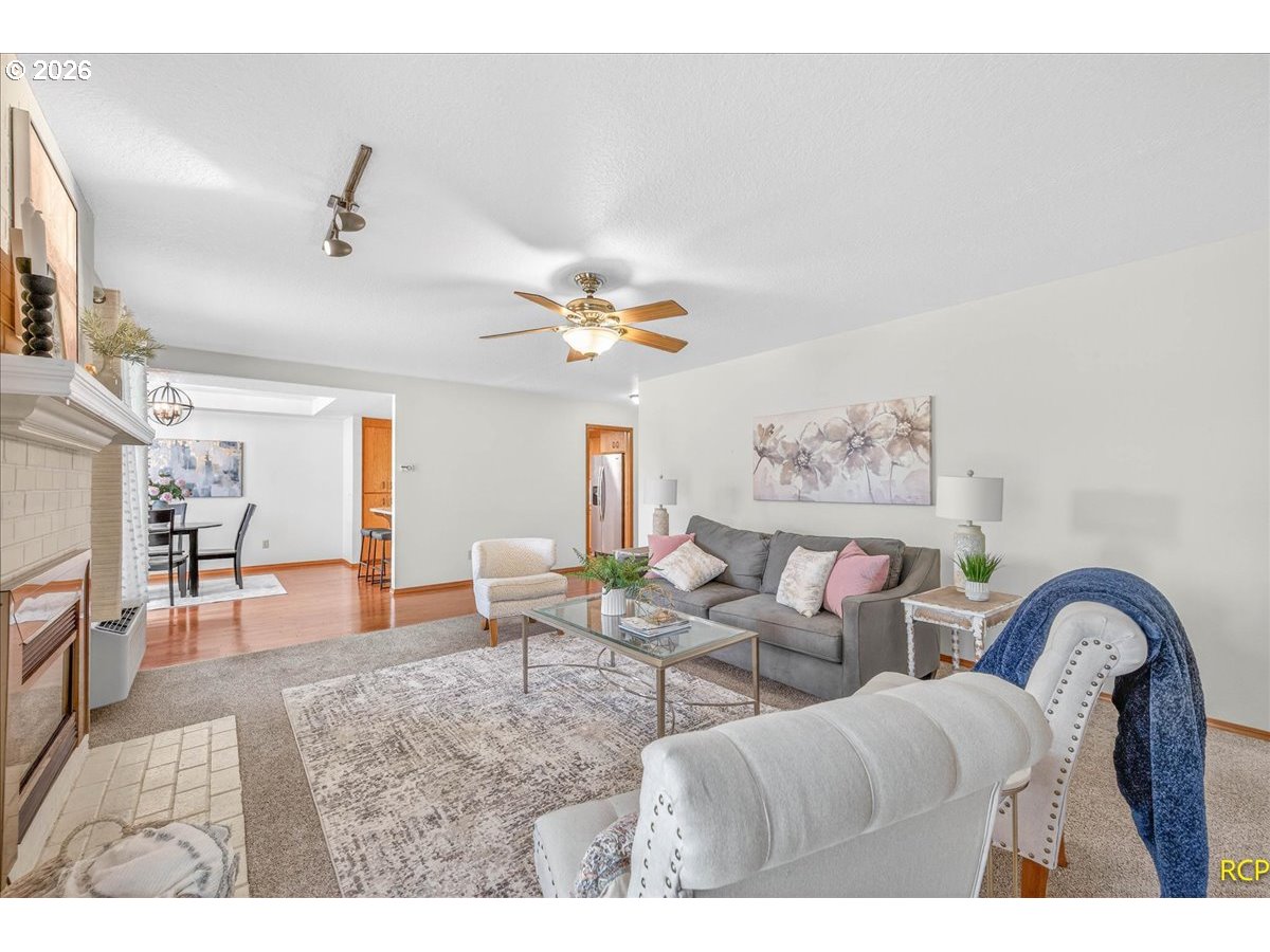 16444 Southwest 130th Terrace, Unit 121 Portland, OR 97224 - Photo 10 of 40 a living room with furniture and a chandelier