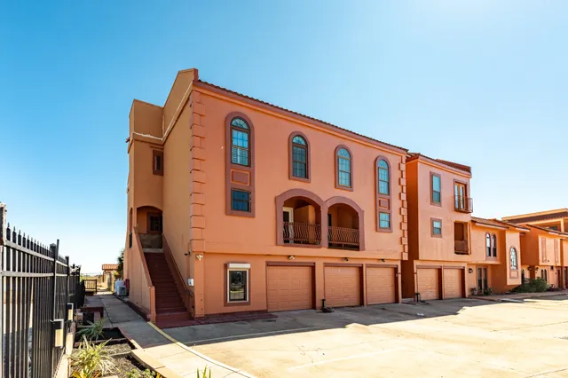 a view of a balcony with a floor to ceiling window and stairs
