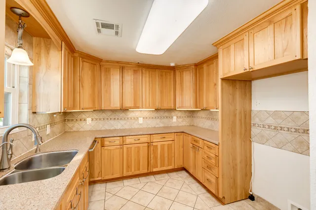 a kitchen with stainless steel appliances a sink stove and cabinets
