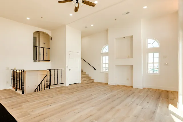 a view of an empty room with a fireplace and a window