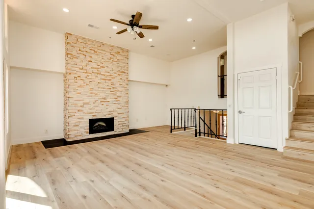a view of a livingroom with wooden floor and a window