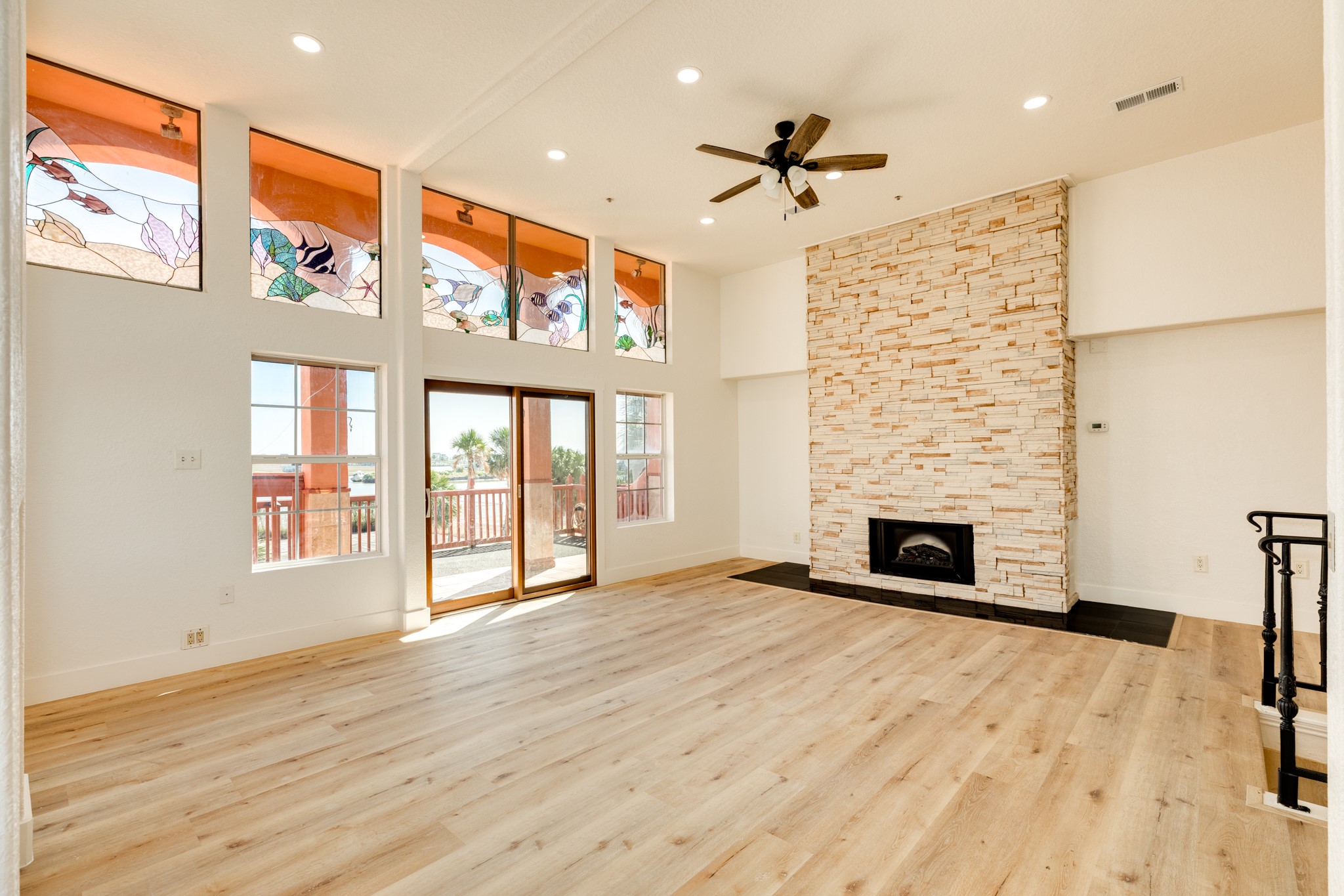 411 Sailfish Lane, Unit 101 Freeport, TX 77541 - Photo 3 of 46 a view of an empty room with wooden floor and a fireplace