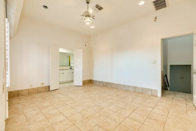 a spacious bathroom with a shower a sink and a mirror
