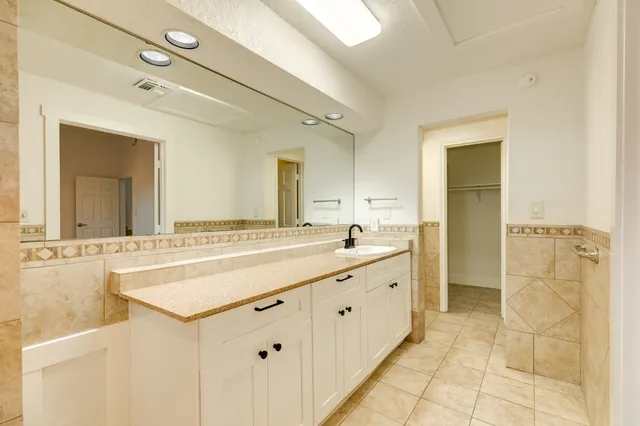 a bathroom with a sink mirror toilet and shower