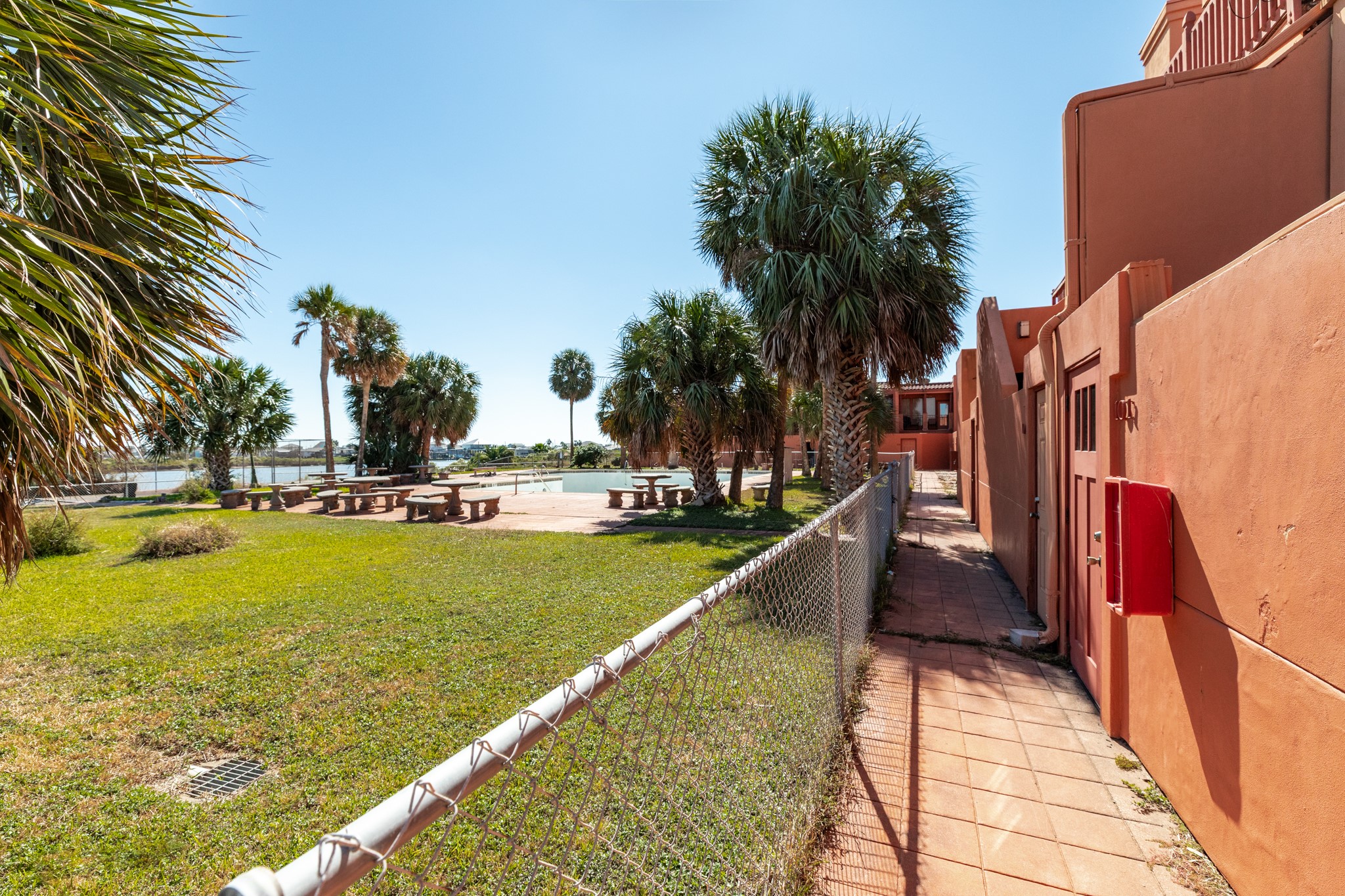 411 Sailfish Lane, Unit 101 Freeport, TX 77541 - Photo 43 of 46 a view of swimming pool with outdoor seating and trees