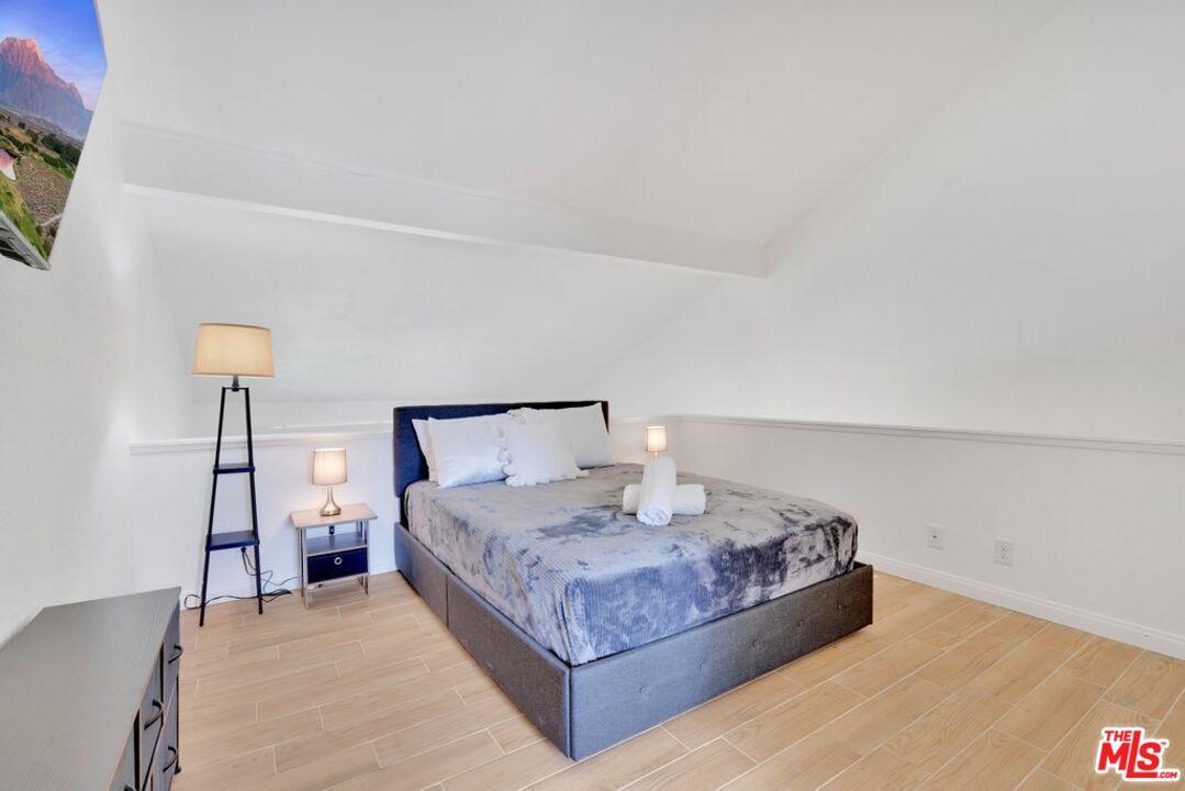 48255 Monroe Street, Unit 56 Indio, CA 92201 - Photo 14 of 30 a bedroom with a bed and a night stand
