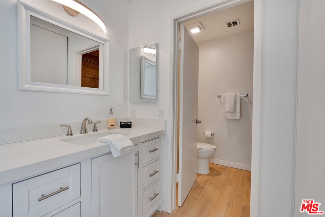 48255 Monroe Street, Unit 56 Indio, CA 92201 - Photo 15 of 30 a bathroom with a double vanity sink toilet and a mirror