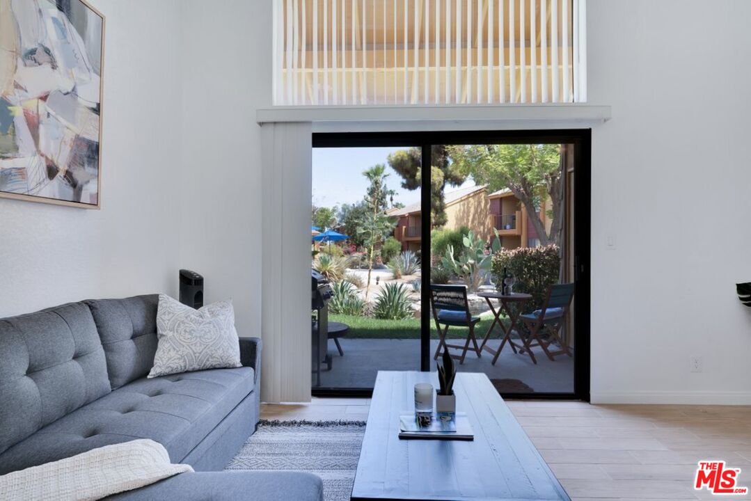 48255 Monroe Street, Unit 56 Indio, CA 92201 - Photo 2 of 30 a living room with furniture and a floor to ceiling window