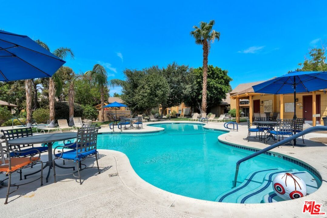 48255 Monroe Street, Unit 56 Indio, CA 92201 - Photo 23 of 30 a view of a swimming pool with a patio