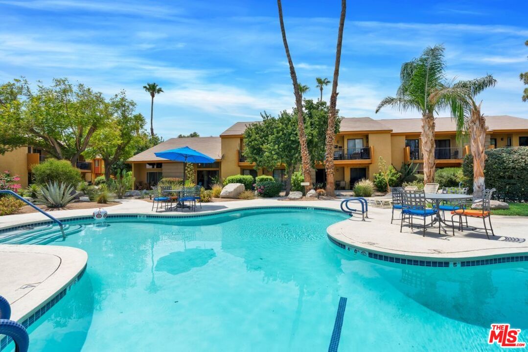 48255 Monroe Street, Unit 56 Indio, CA 92201 - Photo 24 of 30 a view of a house with swimming pool and sitting area
