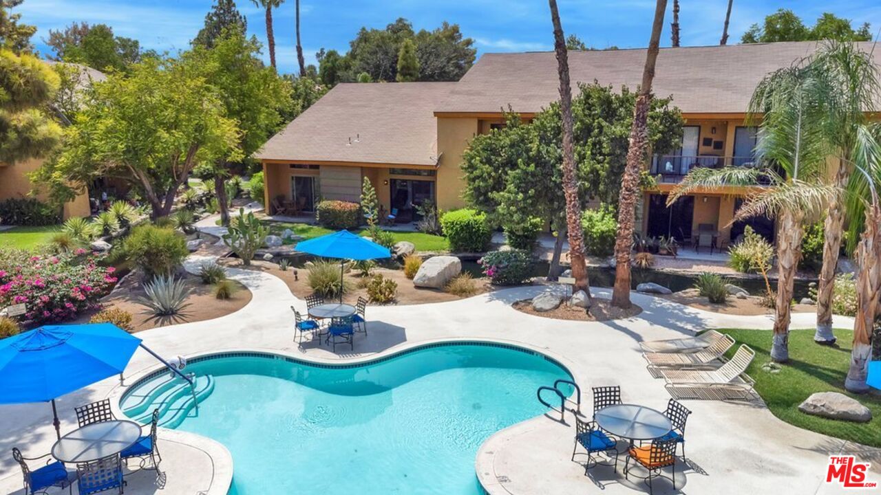 48255 Monroe Street, Unit 56 Indio, CA 92201 - Photo 25 of 30 a view of a patio with table and chairs potted plants