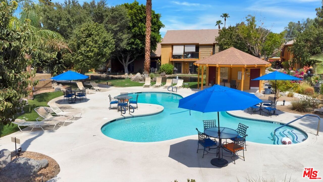 48255 Monroe Street, Unit 56 Indio, CA 92201 - Photo 26 of 30 a view of a house with pool and chairs