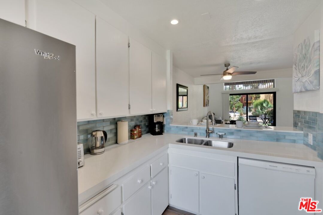 48255 Monroe Street, Unit 56 Indio, CA 92201 - Photo 6 of 30 a kitchen with a sink cabinets and window