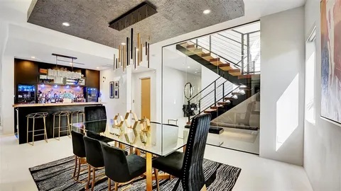 a bedroom with furniture and a large window