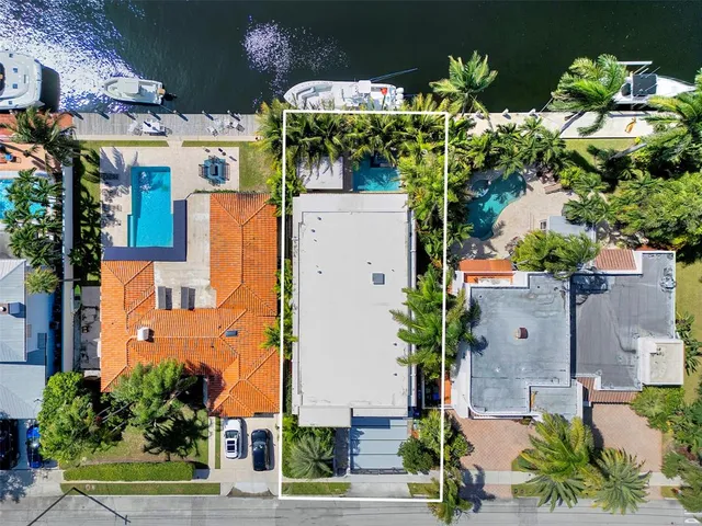 an aerial view of residential houses with city view
