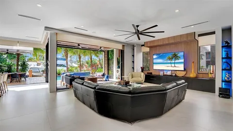 a living room with fireplace furniture and a large window