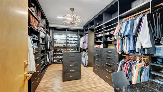 a kitchen with stainless steel appliances granite countertop a sink a stove a refrigerator and island